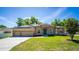 Beautiful single Gathering home featuring a well maintained lawn, solar panels, and a three car garage at 475 Pitt St, Clermont, FL 34711