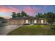 Beautiful single Gathering home featuring a well maintained lawn, solar panels, and a three car garage at 475 Pitt St, Clermont, FL 34711