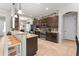 Well-equipped kitchen featuring granite countertops, dark cabinetry, a breakfast bar, and stainless steel appliances at 475 Pitt St, Clermont, FL 34711