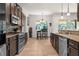 Stylish kitchen with stainless steel appliances, dark cabinetry, granite countertops, and a cozy dining area at 475 Pitt St, Clermont, FL 34711
