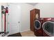 Laundry room with cabinetry and modern washer and dryer at 475 Pitt St, Clermont, FL 34711