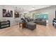 Open-concept living room with tile flooring, ceiling fan, and breakfast bar leading to the kitchen at 475 Pitt St, Clermont, FL 34711