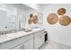 Bathroom with double sinks, granite countertops, decorative wall hangings and tile flooring at 4770 Cloister St, Kissimmee, FL 34758