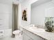 Bathroom featuring a tub shower with curtain, granite counters and modern fixtures at 4770 Cloister St, Kissimmee, FL 34758