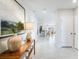 Bright hallway showcasing tiled floors and a glimpse into the modern open-concept kitchen and living area at 4770 Cloister St, Kissimmee, FL 34758