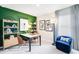 Stylish home office featuring a modern desk, shelving, and a comfortable blue armchair at 4770 Cloister St, Kissimmee, FL 34758