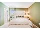 Main bedroom with a king-size bed, natural light, and stylish bedside tables, creating a relaxing atmosphere at 4770 Cloister St, Kissimmee, FL 34758