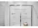Bathroom shower featuring seamless glass doors, tiled walls and built-in shelving at 4770 Cloister St, Kissimmee, FL 34758