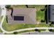 Aerial view of home with a well-maintained yard and modern solar panels at 5052 Blanchard Ct, St Cloud, FL 34772