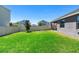 Spacious back yard area enclosed by a white fence and green grass at 5052 Blanchard Ct, St Cloud, FL 34772