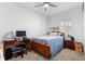 Cozy bedroom with natural light, a ceiling fan, and a wooden desk workspace at 5052 Blanchard Ct, St Cloud, FL 34772
