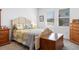 Comfortable bedroom with a decorative bed frame, dresser, and natural lighting at 5052 Blanchard Ct, St Cloud, FL 34772