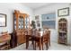 Cozy dining room featuring a wooden table, a china cabinet, and bright natural light at 5052 Blanchard Ct, St Cloud, FL 34772
