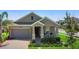 Charming single-story home with a well-maintained lawn, covered front porch, and attached garage at 5052 Blanchard Ct, St Cloud, FL 34772