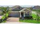 Beautiful single-Gathering home featuring a brick driveway, manicured lawn, and covered front porch at 5052 Blanchard Ct, St Cloud, FL 34772