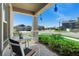 Cozy front porch view with seating area, showcasing the neighborhood street and blue skies at 5052 Blanchard Ct, St Cloud, FL 34772