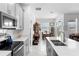 Bright kitchen with stainless steel appliances and a view of the dining area and backyard at 5052 Blanchard Ct, St Cloud, FL 34772