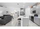 Open-concept kitchen with gray cabinets, a large island, and stainless steel appliances in a well lit room at 5052 Blanchard Ct, St Cloud, FL 34772