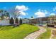Well-manicured lawn with walkway, fire pit, and screened pool area offers an inviting outdoor space at 5263 Jade Cir, Belle Isle, FL 32812
