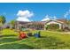 Expansive backyard featuring a screened pool area, fire pit, seating and beautiful landscaping at 5263 Jade Cir, Belle Isle, FL 32812