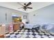This bedroom features a black and white floor, a ceiling fan, and a desk at 5263 Jade Cir, Belle Isle, FL 32812