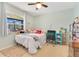 Cozy bedroom with a large window, desk area, and plenty of natural light at 5263 Jade Cir, Belle Isle, FL 32812