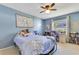 Charming bedroom featuring blue walls, cozy furnishings, and a ceiling fan at 5263 Jade Cir, Belle Isle, FL 32812