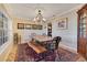 Elegant dining room with wood table, oriental rug, and decorative lighting, perfect for entertaining at 5263 Jade Cir, Belle Isle, FL 32812