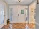 Welcoming foyer featuring elegant double doors with sidelights and terra cotta tile flooring at 5263 Jade Cir, Belle Isle, FL 32812