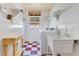 Clean laundry room with sink, washer, dryer, and ample storage shelves at 5263 Jade Cir, Belle Isle, FL 32812