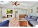Inviting living room featuring a cozy fireplace, vaulted ceiling, skylight, and terra cotta floors at 5263 Jade Cir, Belle Isle, FL 32812