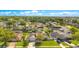 Aerial view of a lush, green neighborhood showcasing well-maintained homes and vibrant landscaping at 5263 Jade Cir, Belle Isle, FL 32812