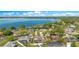 Aerial shot of a charming lakeside neighborhood boasting lush foliage and well-kept houses at 5263 Jade Cir, Belle Isle, FL 32812