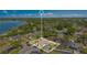 Aerial shot of lakeside home in lush neighborhood with pool and outdoor living space, city skyline in distance at 5263 Jade Cir, Belle Isle, FL 32812