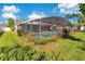 A screened pool with beautiful landscaping and outdoor seating offers a relaxing backyard oasis at 5263 Jade Cir, Belle Isle, FL 32812