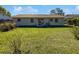 Spacious backyard with a well-maintained lawn and a private patio area at 5618 Carris Ct, Orlando, FL 32810