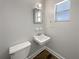 Efficient bathroom showcasing a classic white sink and toilet with a bright window view at 5618 Carris Ct, Orlando, FL 32810