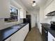 Well-lit kitchen featuring white cabinetry, black appliances, and modern fixtures at 5618 Carris Ct, Orlando, FL 32810