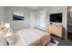 Serene main bedroom featuring a soothing color scheme, ample closet space, and television at 5618 Carris Ct, Orlando, FL 32810