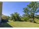 Lush backyard with mature trees and a hot tub offers a private outdoor space at 5694 Aragon Ave, De Leon Springs, FL 32130