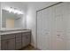 Stylish bathroom with double sinks, granite countertops, and ample closet space at 5694 Aragon Ave, De Leon Springs, FL 32130