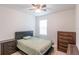 Cozy bedroom with a bed, nightstand, dresser, and a window for natural light at 5694 Aragon Ave, De Leon Springs, FL 32130