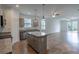 Bright, open kitchen with granite countertops, stainless steel appliances, and an island with pendant lighting at 5694 Aragon Ave, De Leon Springs, FL 32130