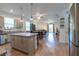 Open-concept kitchen with island, stainless steel appliances, and seamless flow to the living area at 5694 Aragon Ave, De Leon Springs, FL 32130