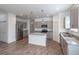 Modern kitchen features stainless steel appliances, granite countertops, gray cabinets, and an island at 5694 Aragon Ave, De Leon Springs, FL 32130