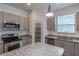 Well-appointed kitchen with stainless steel appliances, granite countertops, and a convenient pantry at 5694 Aragon Ave, De Leon Springs, FL 32130