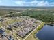 Captivating aerial perspective showcases a community near a lush forest with a serene lake at 6525 Rover Way, St Cloud, FL 34771