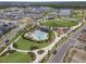 Overhead shot showcasing the community pool, clubhouse, playground, expansive green spaces, and landscaping at 6525 Rover Way, St Cloud, FL 34771