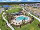 Beautiful aerial view of a neighborhood with lush green spaces, walking paths, and a serene lake at 6525 Rover Way, St Cloud, FL 34771