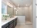 Modern bathroom with double vanity, quartz countertop and a tiled shower at 6525 Rover Way, St Cloud, FL 34771